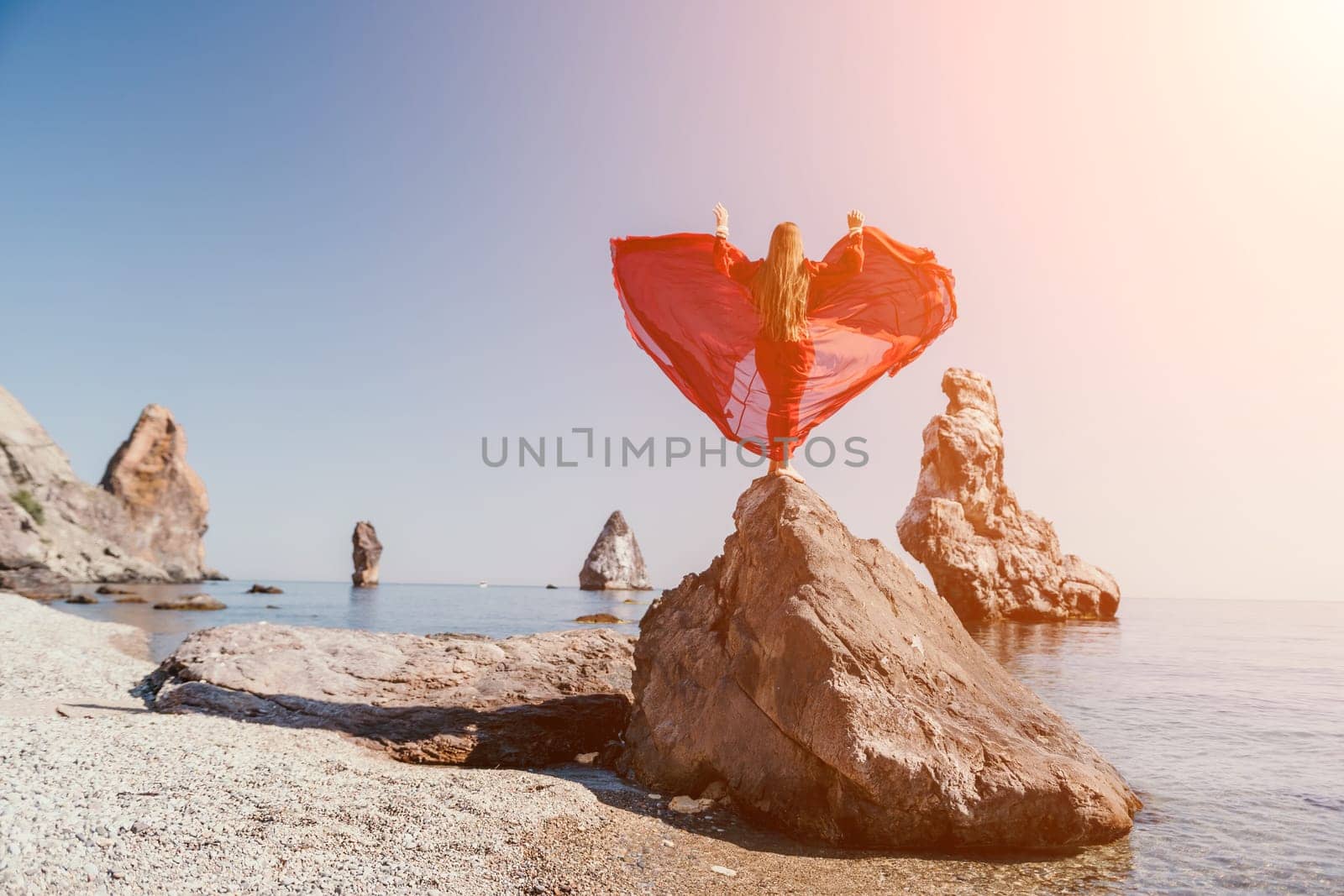 Woman travel sea. Happy tourist taking picture outdoors for memories. Woman traveler looks at the edge of the cliff on the sea bay of mountains, sharing travel adventure journey.