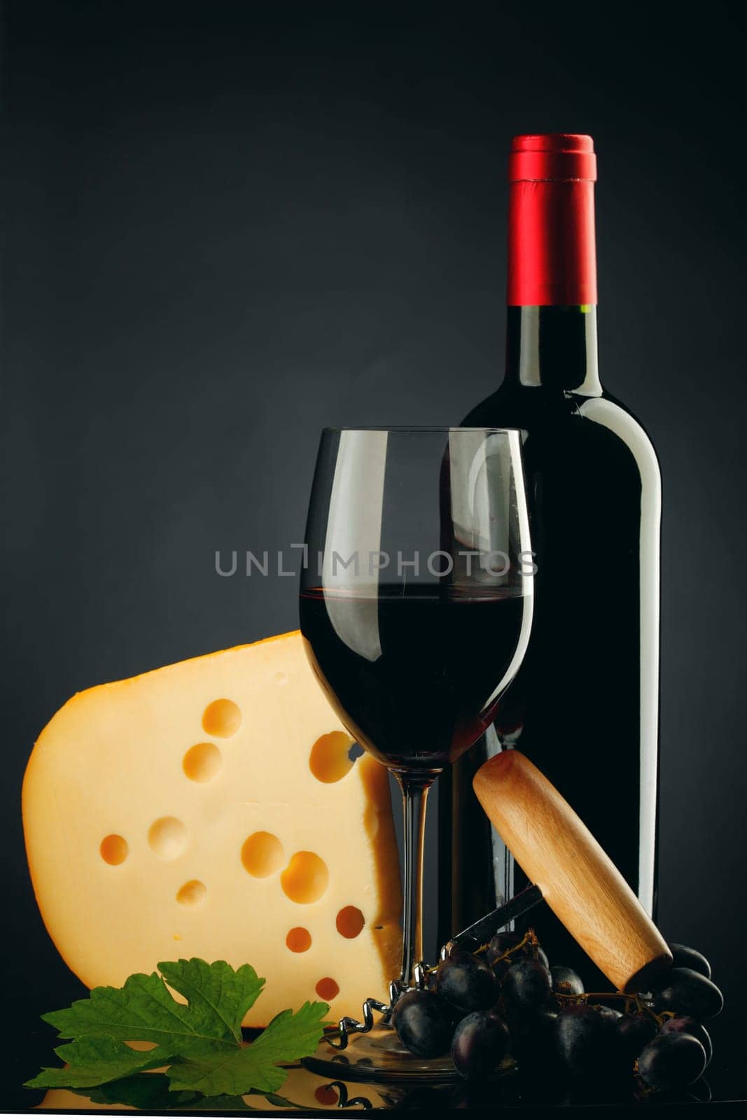 red wine and cheese on black