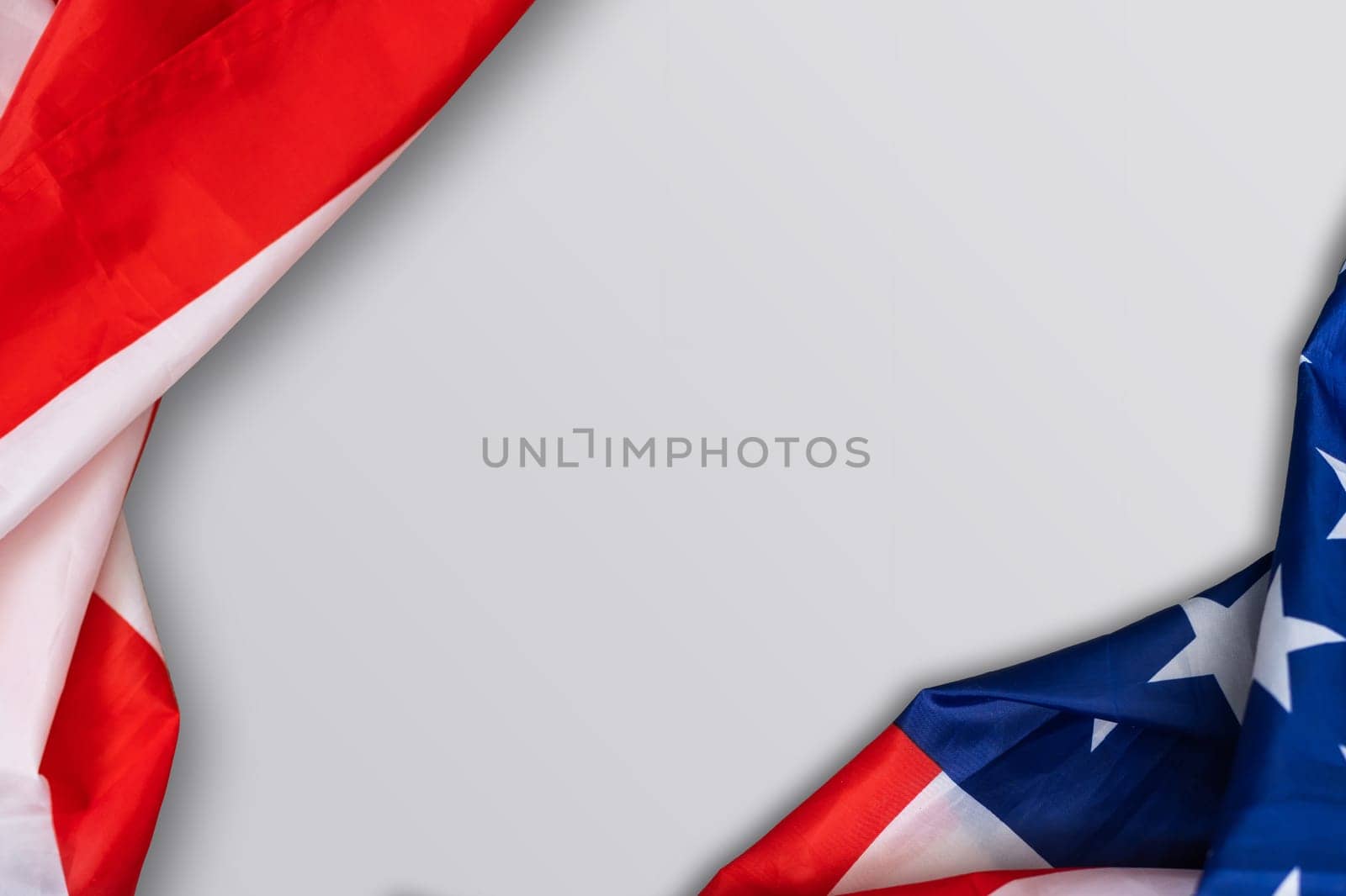 Closeup of American flag on plain background.