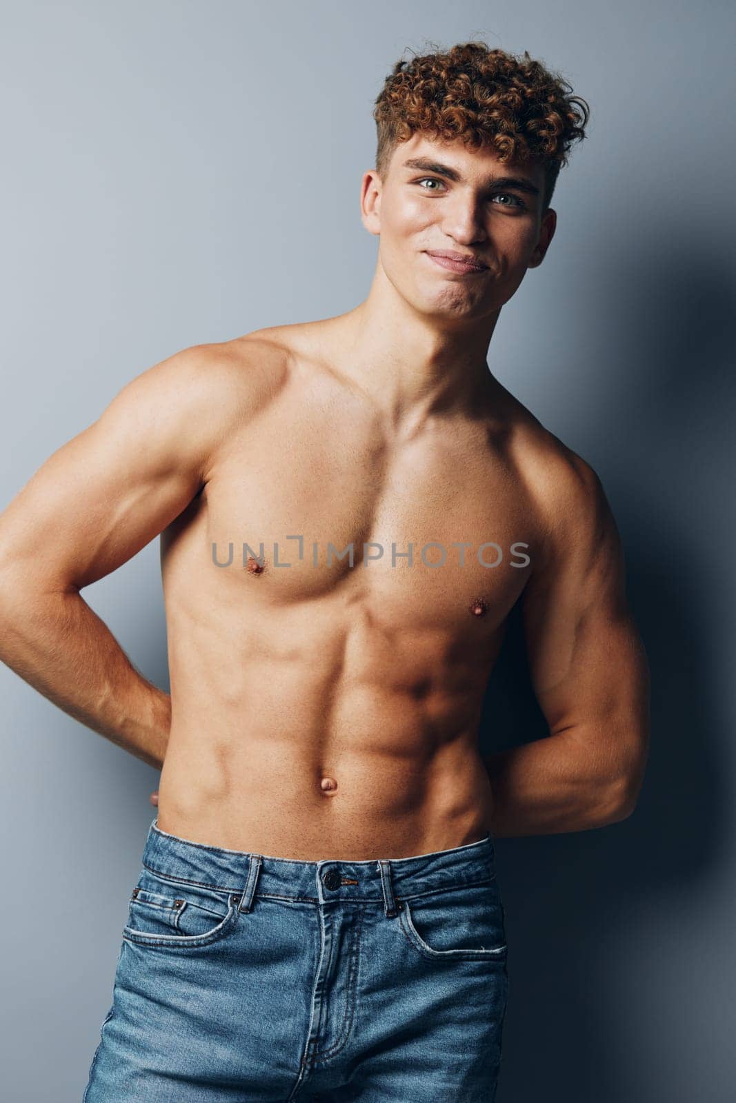 man standing handsome athlete male guy sport chest gray jeans smile person by SHOTPRIME