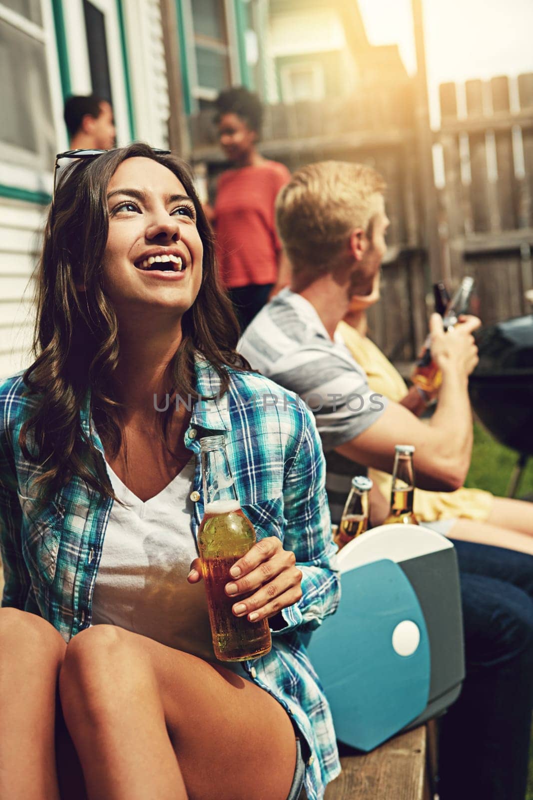 Its going to be the best weekend. a young woman enjoying a party with friends outdoors. by YuriArcurs