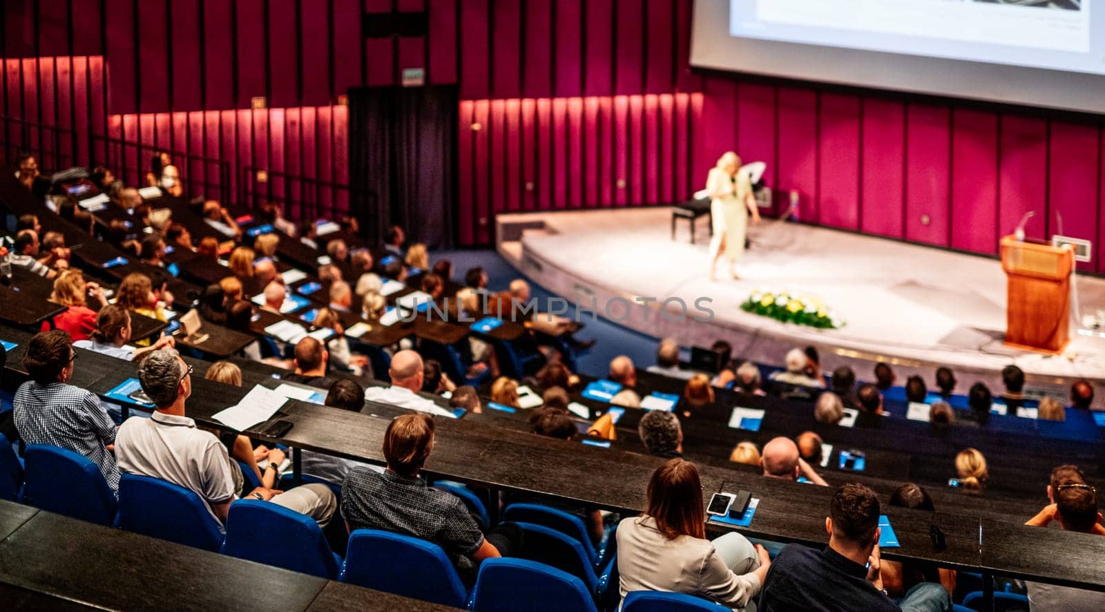 Woman giving presentation on business conference event. by kasto