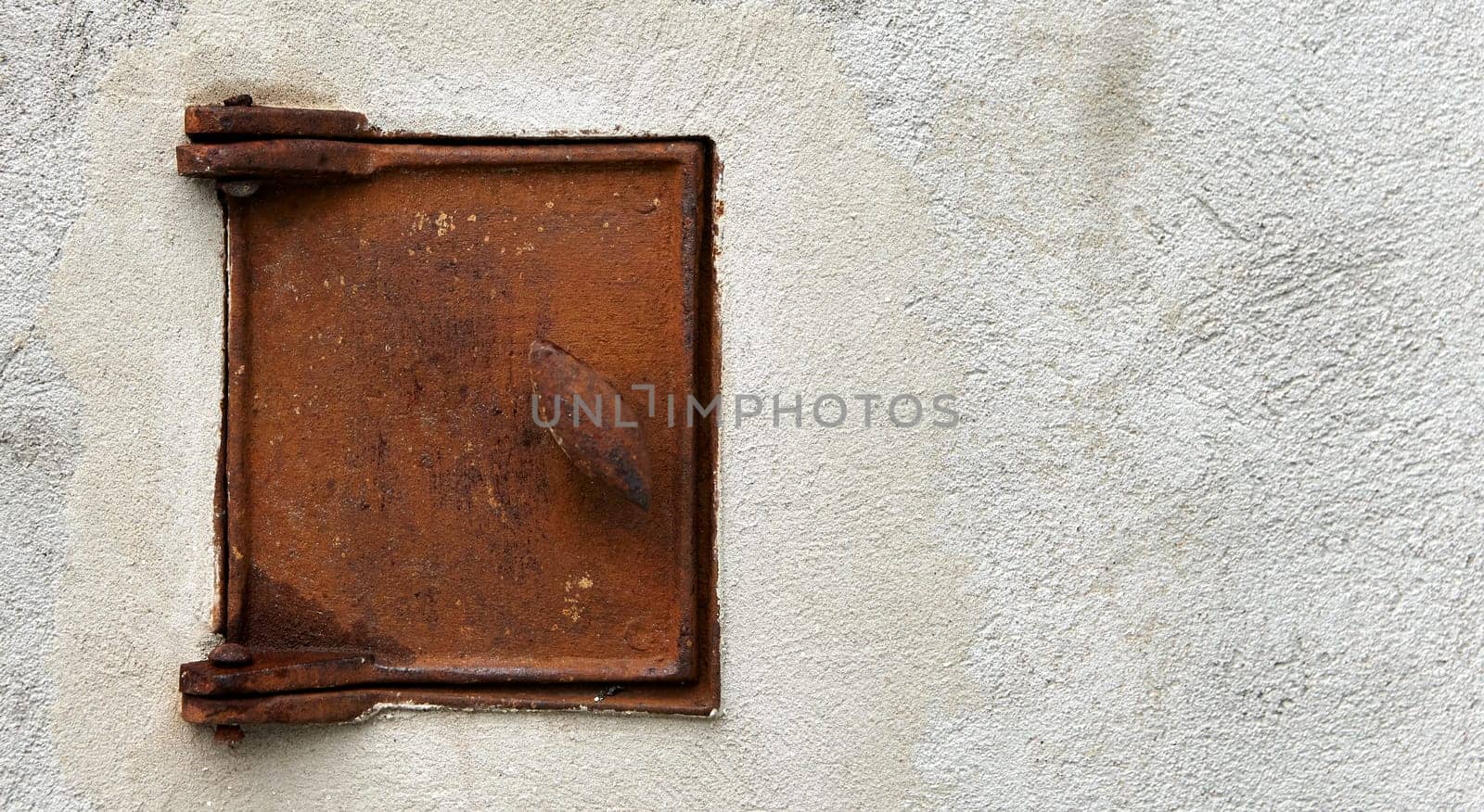 rusty oven door on a plastered wall vintage, background image, rust on the door.