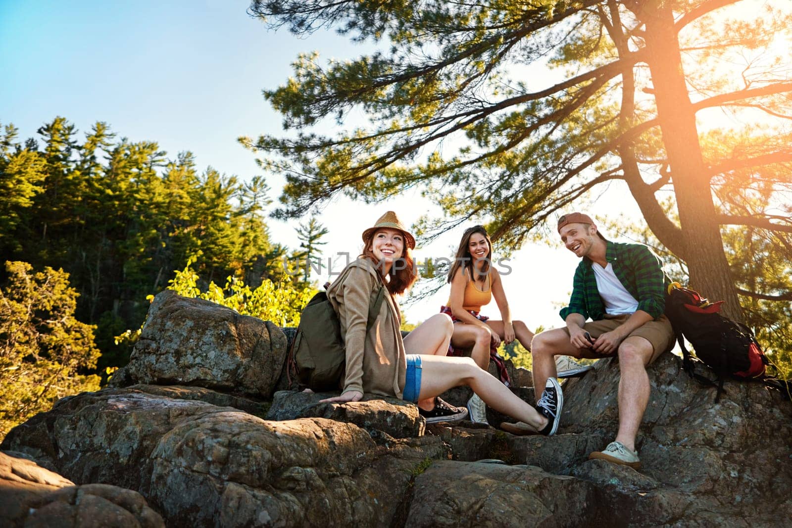 You see more when you travel by foot. three young people hiking while on an overseas trip