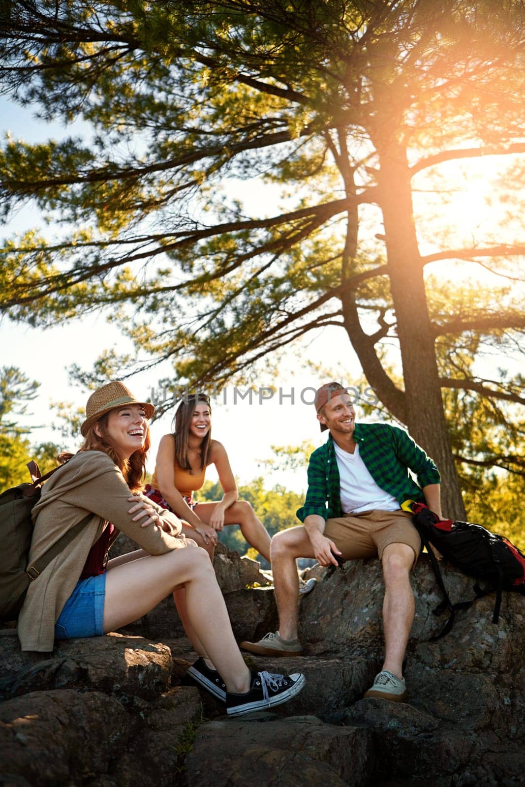 The sun shines on those who let it. three young people hiking while on an overseas trip