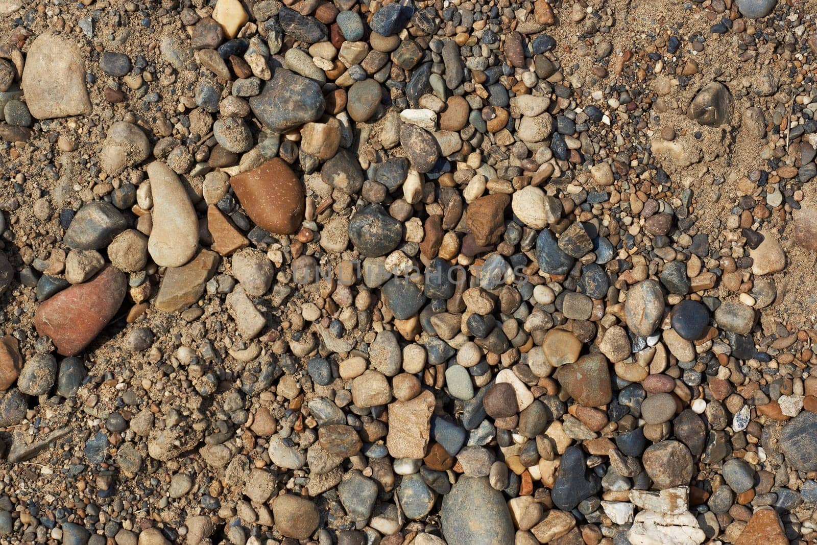 Texture; top view of the laid out of small and large stones and sand