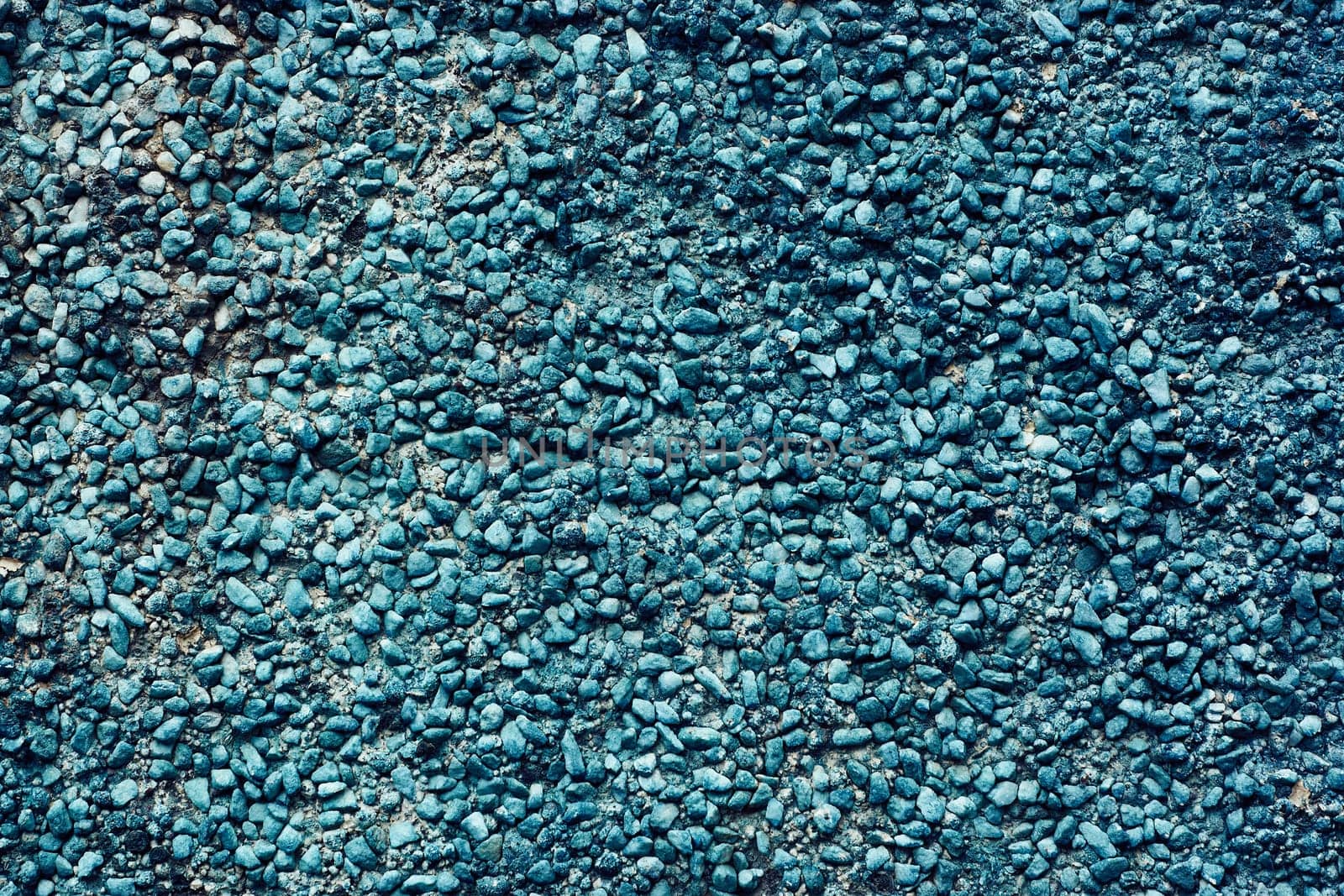 Texture of dark blue pebbles, abstract background of small stones