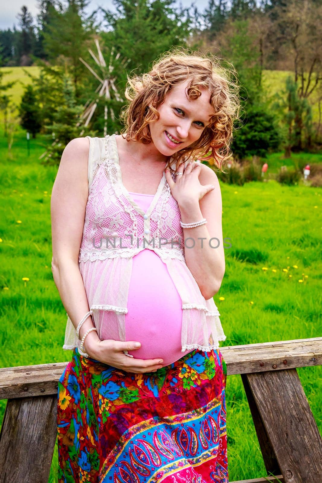 Young beautiful woman with pregnant belly showing.