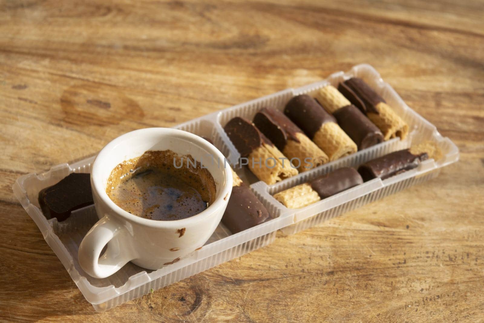 espresso coffee with round wafer cookies with chocolate