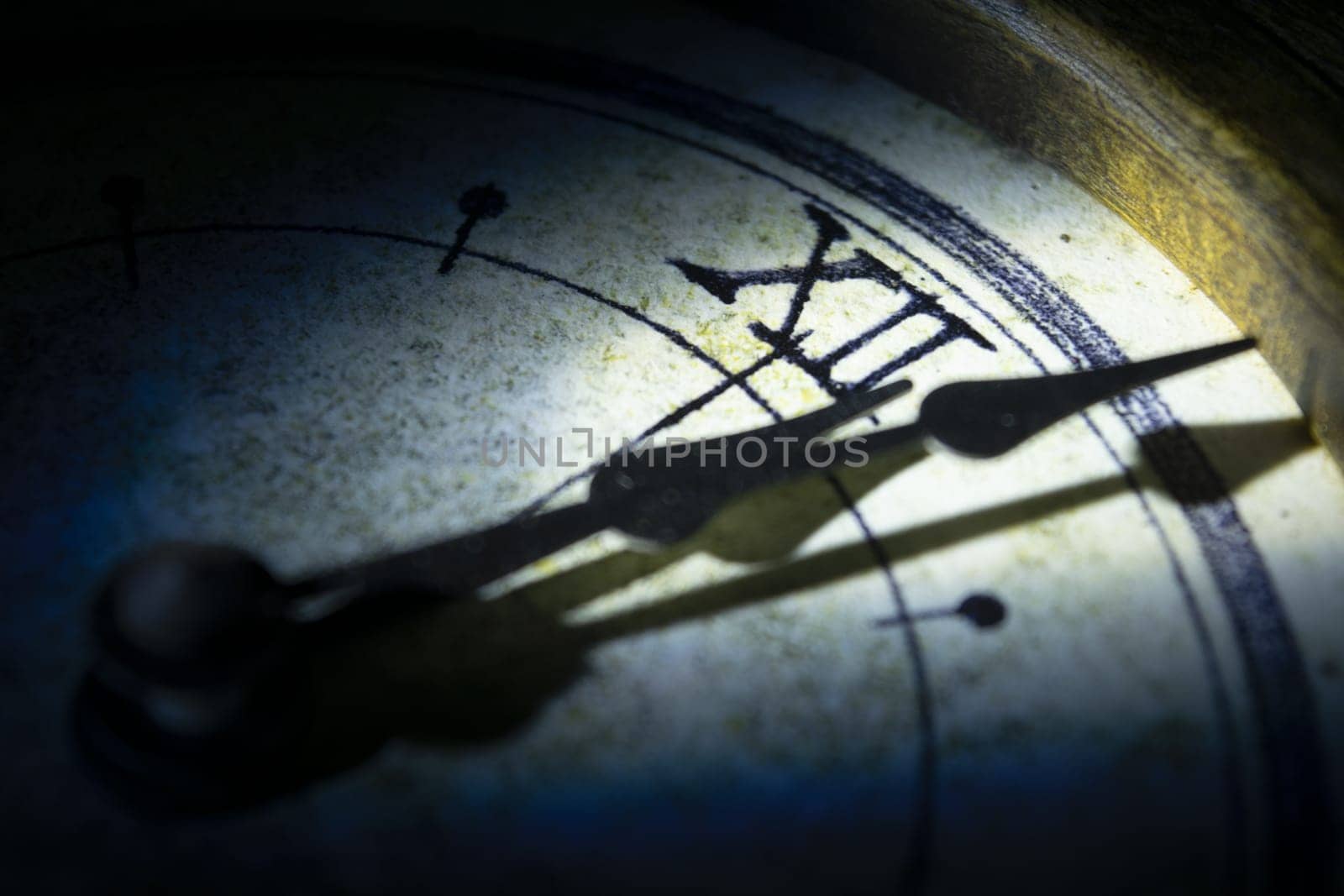 concept of time with the face of an old wall clock in directional light