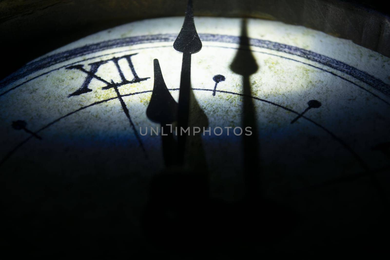 concept of time with the face of an old wall clock in directional light