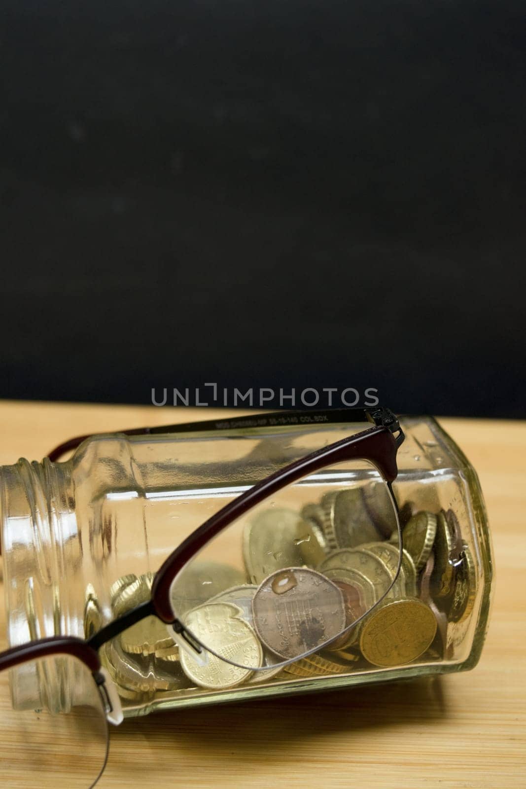 glass jar full of coins for savings concept