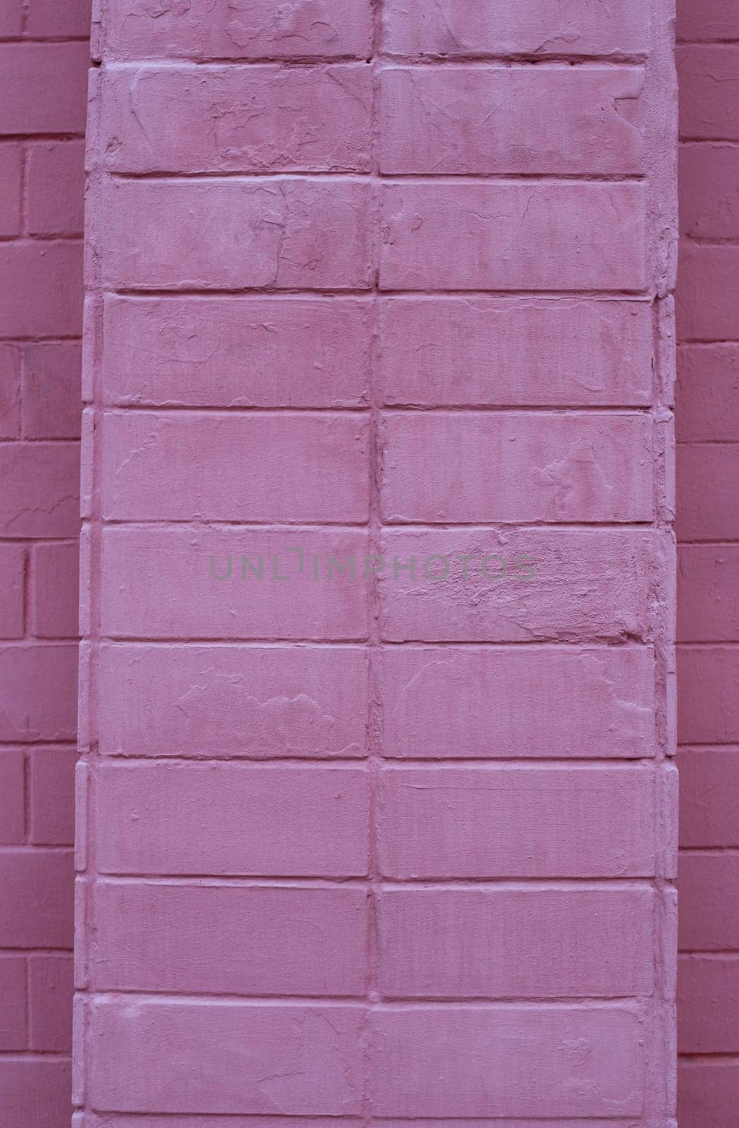 The brick wall of the building is painted red.