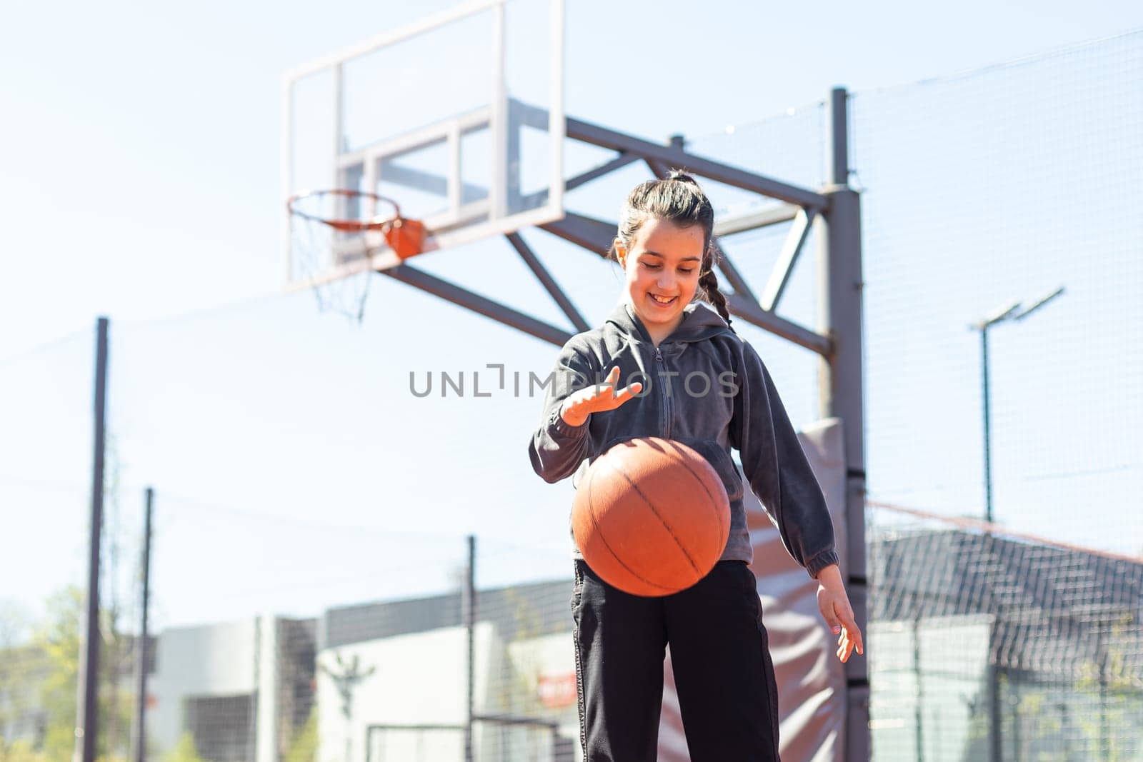 Girl with a basketball on the background of the city. Street basketball. by Andelov13