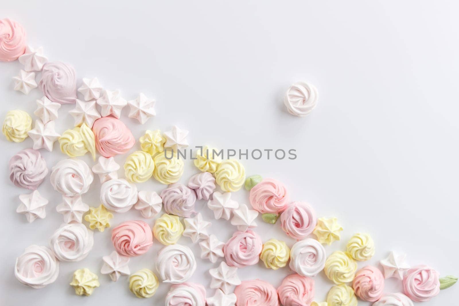 Meringue. Light dessert of whipped egg whites on a white background. copy space