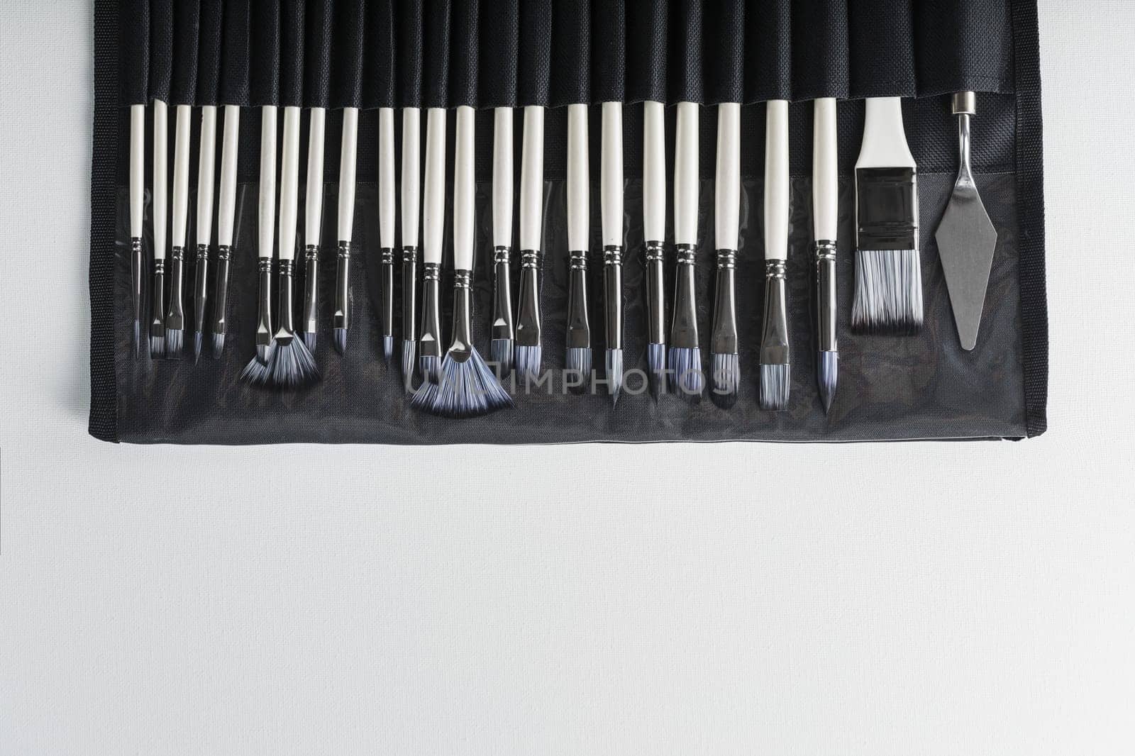 A set of art brushes for drawing on a white background, top view with free space