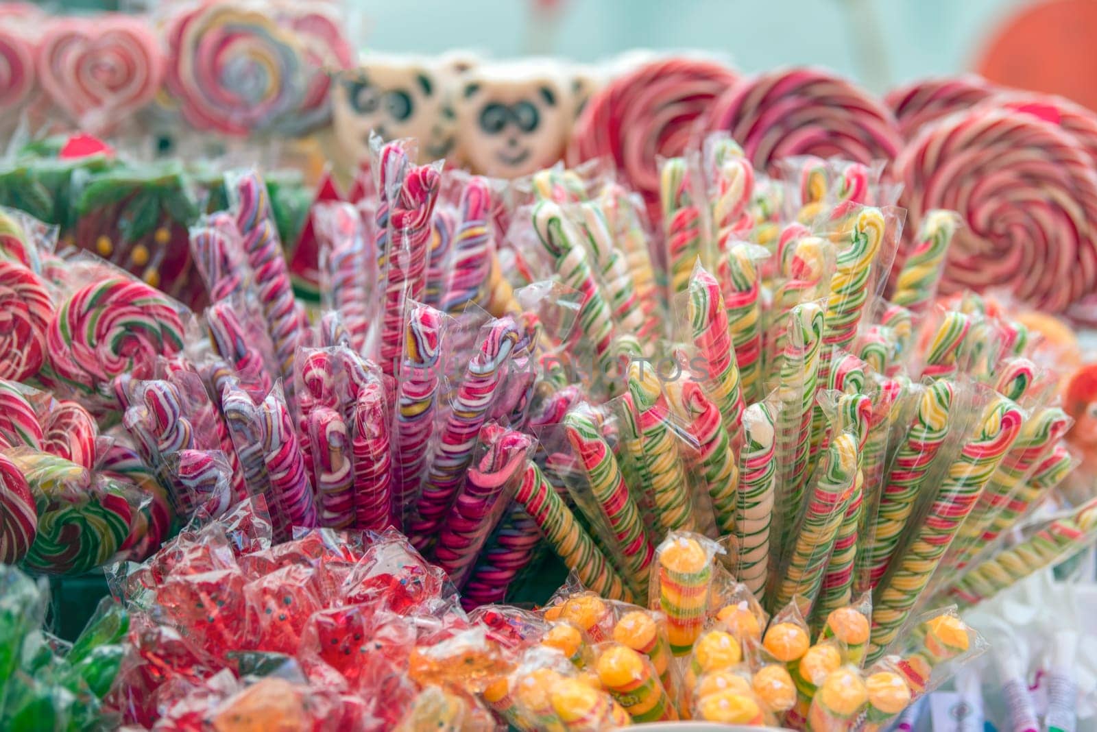 Sweets are harmful to health. Multi-colored sweets with a lot of sugar, in the form of sticks, are sold in a pastry shop. High quality photo