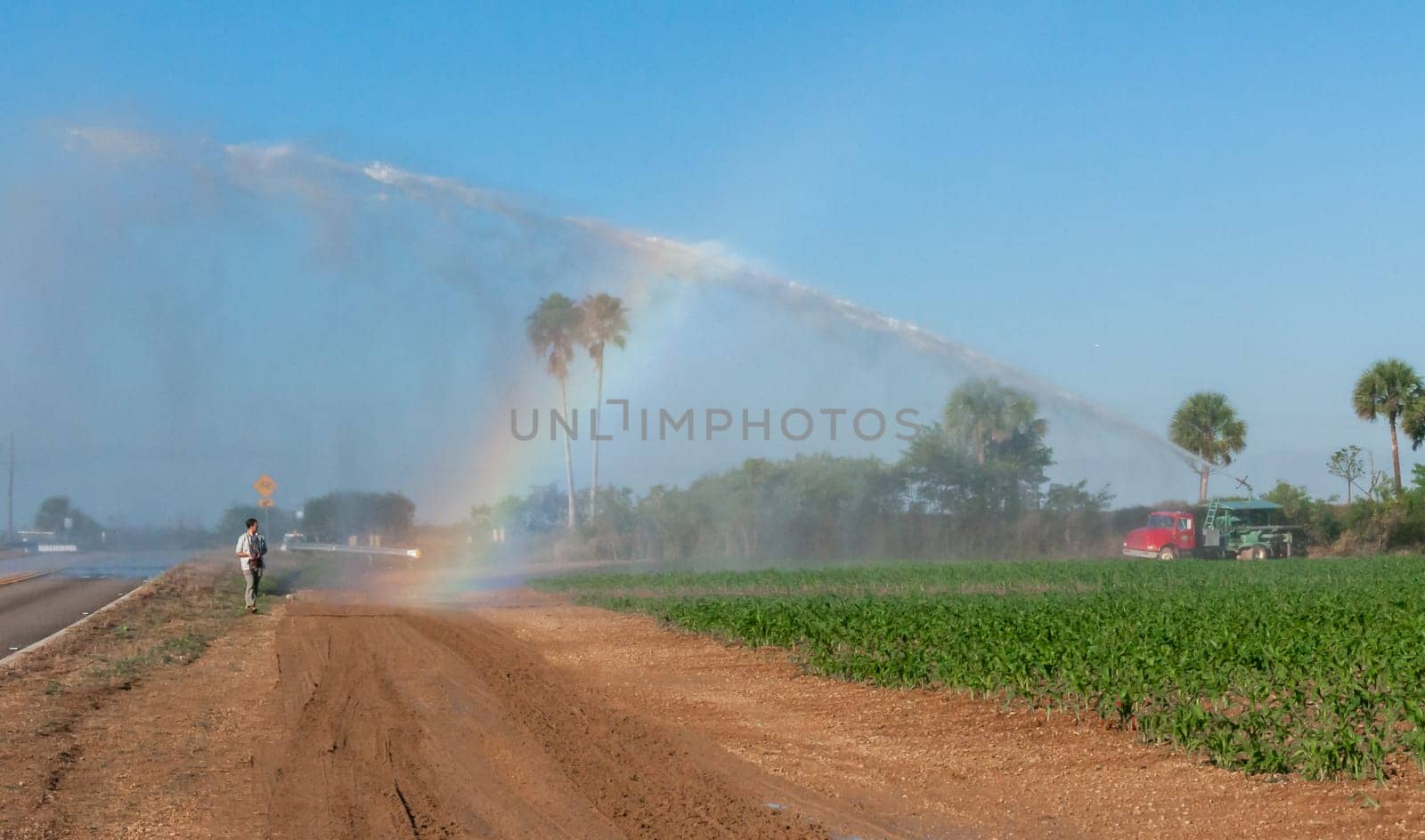 USA, FLORIDA - NOVEMBER 30, 2011: a rainbow in the sky from a fire engine spraying a field, Florida