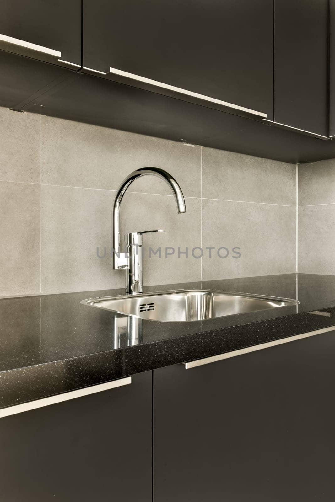 a kitchen sink with a chrome faucet in by casamedia