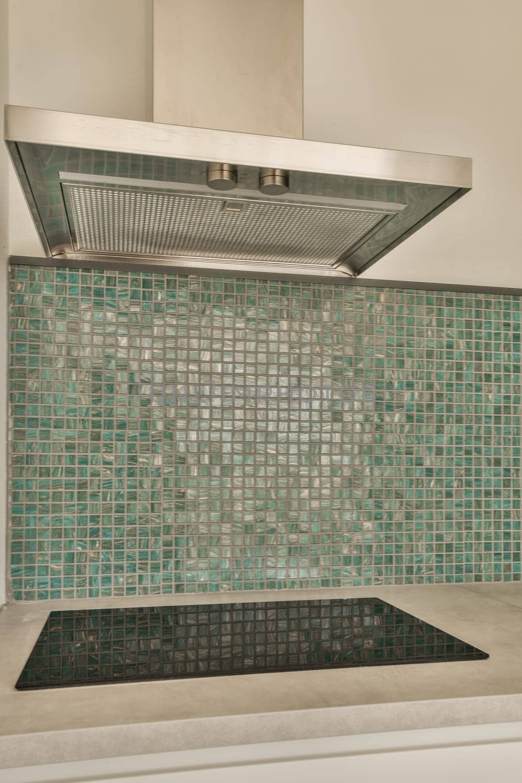 a kitchen with green tiles on the backs of the stoves and range hood in it's centerpiece