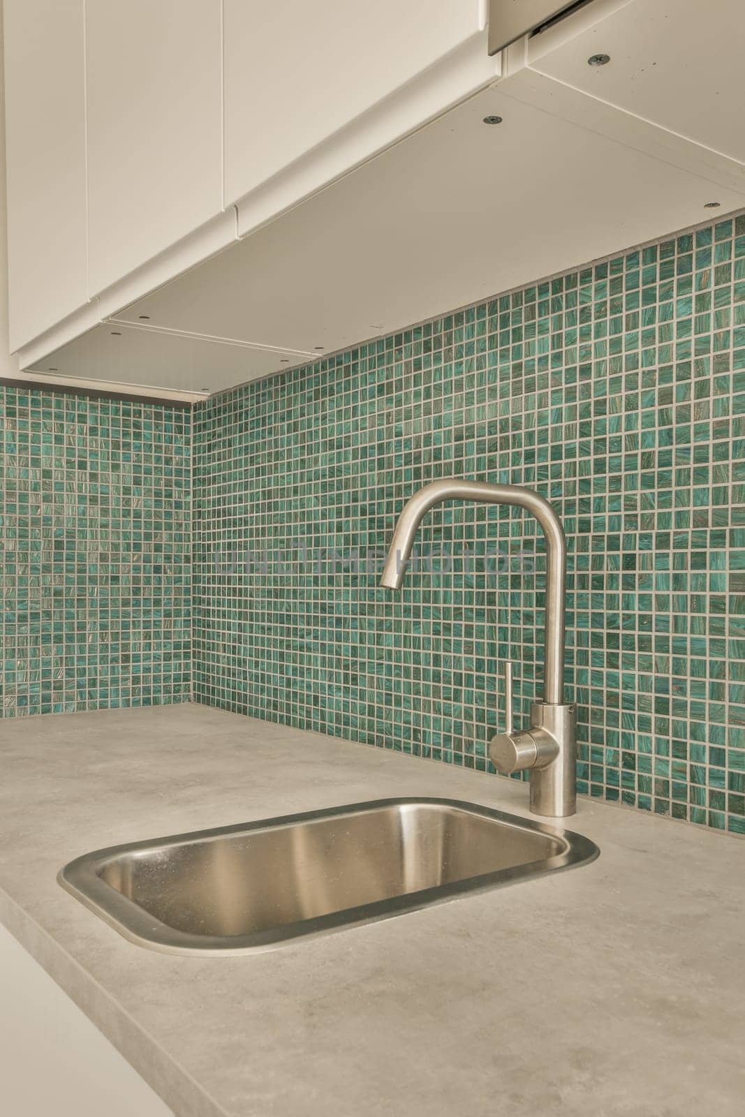 a stainless steel sink in a kitchen with blue tile by casamedia