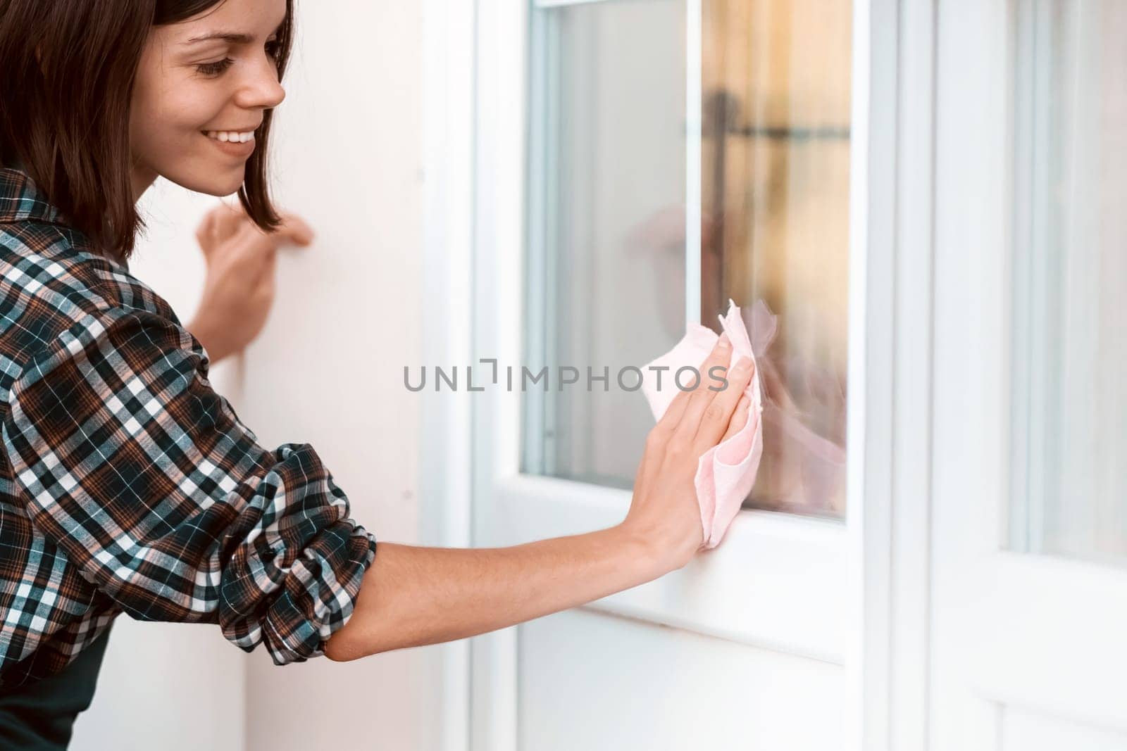 Girl is washing and cleaning the windows. by africapink