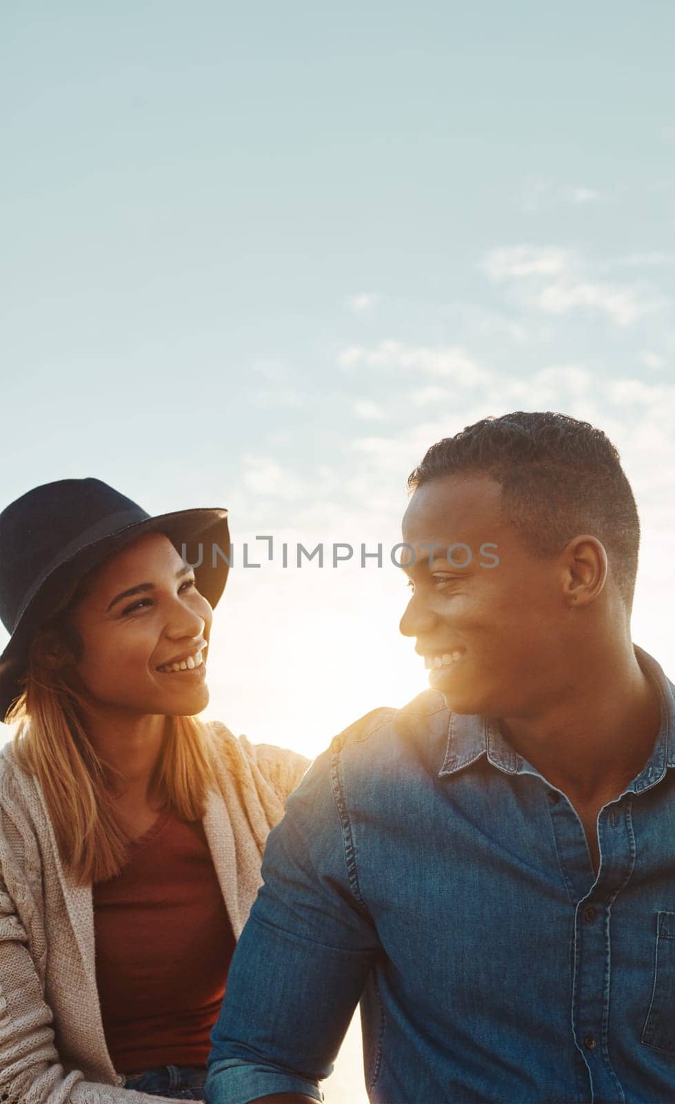 When you smile, I smile. a happy young couple enjoying a romantic day outdoors. by YuriArcurs