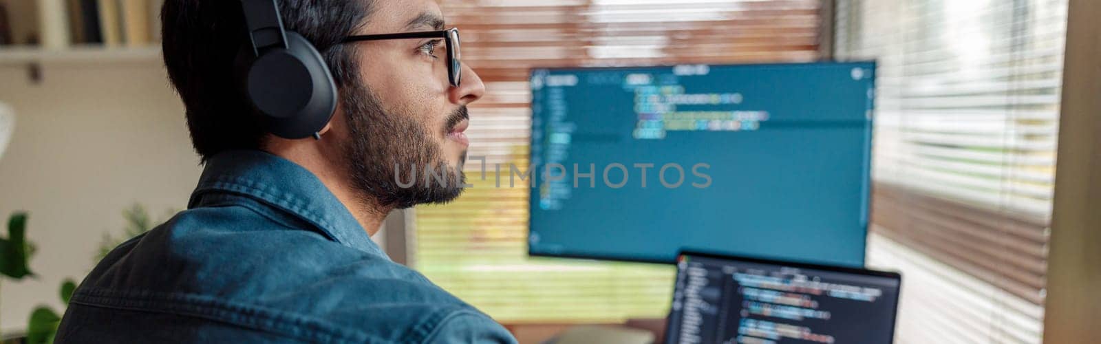 Man in headphones freelance data scientist work remotely at home. High quality photo