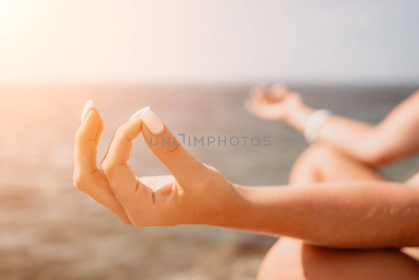 Woman sea yoga. Back view of free calm happy satisfied woman with long hair standing on top rock with yoga position against of sky by the sea. Healthy lifestyle outdoors in nature, fitness concept.