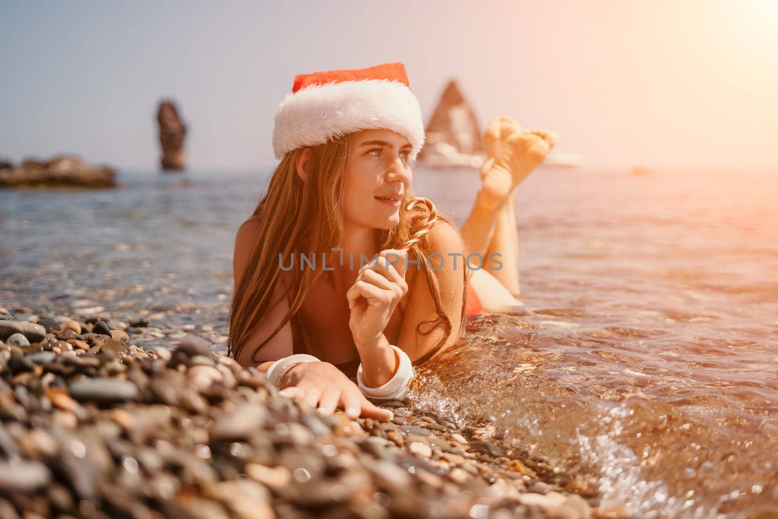 Woman travel sea. Happy tourist taking picture outdoors for memories. Woman traveler looks at the edge of the cliff on the sea bay of mountains, sharing travel adventure journey.