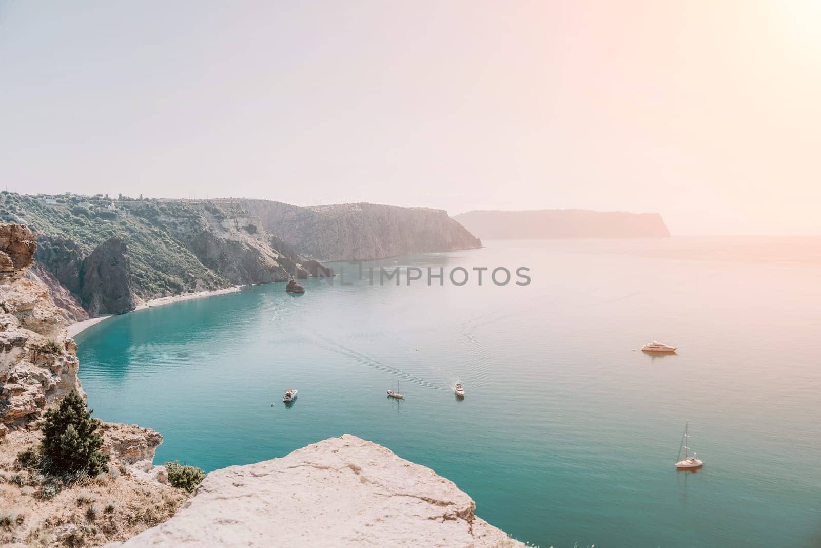 Aerial panoramic view of beautiful sunset above sea. Beautiful seascape. Sun glare, small waves on the water surface. Evening. Horizon. Nobody. No people. Copy space. Never-ending beauty of nature