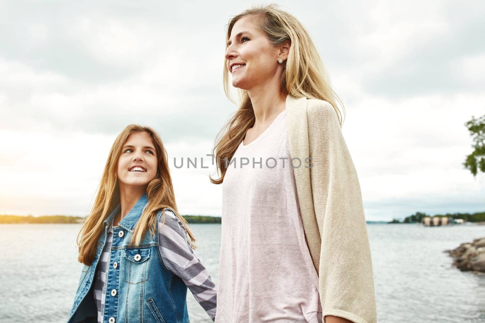 She loves being out and about with Mom. a mother and her daughter bonding outdoors. by YuriArcurs