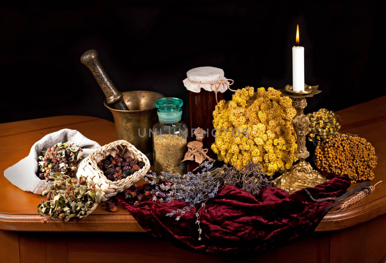 Dried healing herbs, flowers and candles, ritual purification , copyspace Close up of healing herbs alchemist stuff. Old pharmacy, alternative medicine concept. mortar and pestle. on a black background. wooden table. by aprilphoto