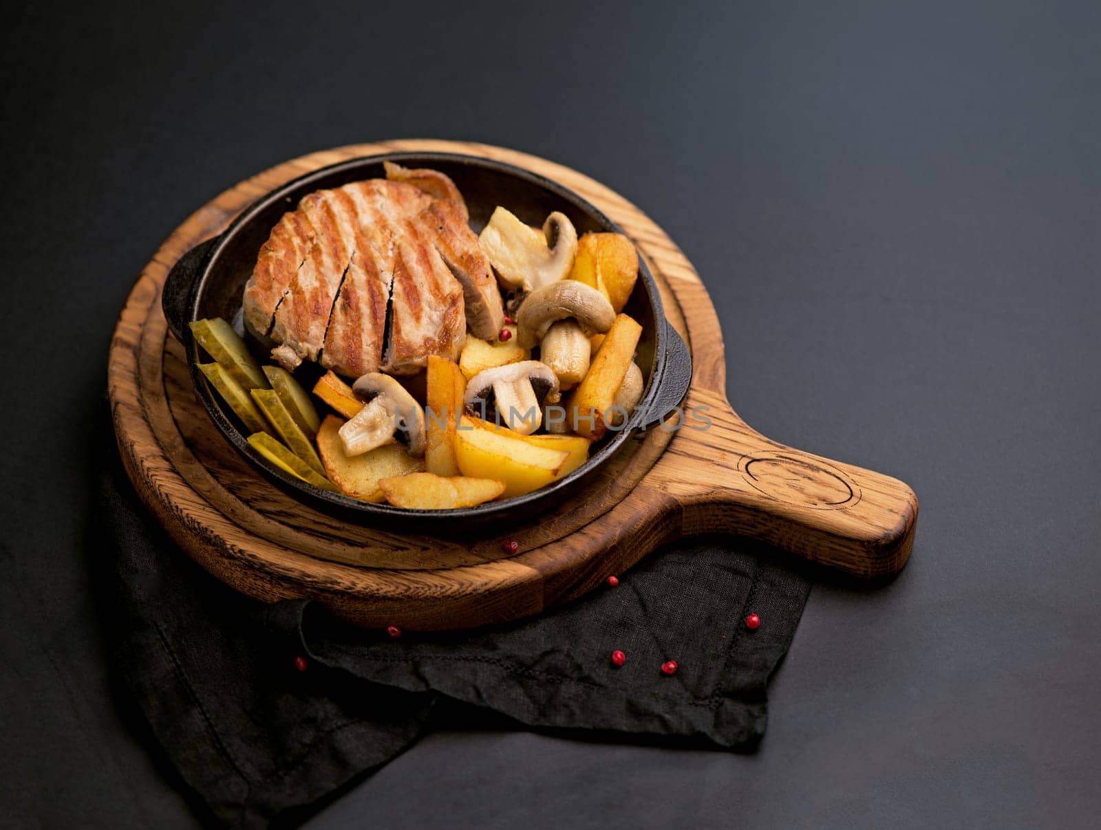 roast with meat and mushrooms. Homemade slow cooked pot with meat mushrooms and potatoes on a black background by aprilphoto