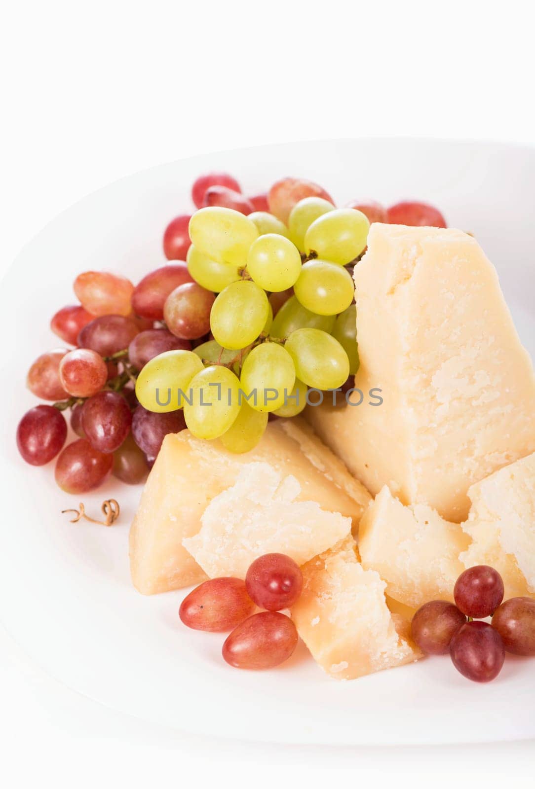 Parmesan cheese and grapes isolated on a white backgroun. View from above