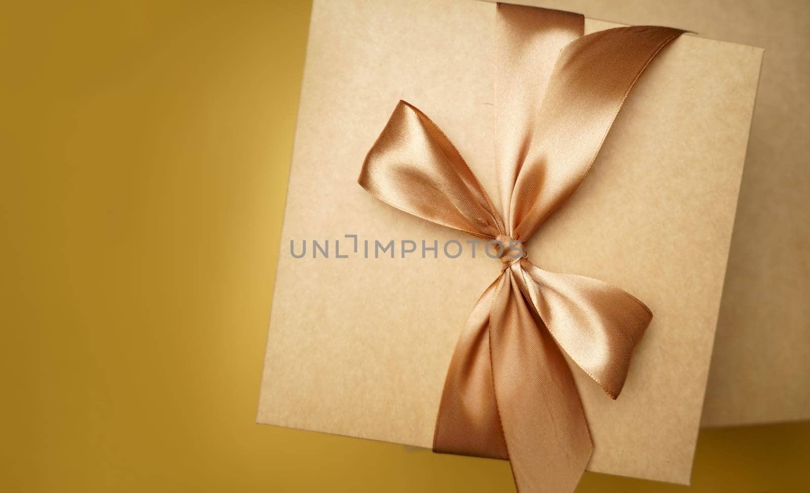 small gift box on yellow background. top view