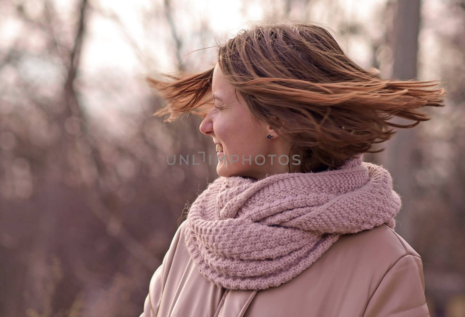 candid attractive young smiling woman walking in park, happy mood, fashion style trend, pink jacket, waving brown hair
