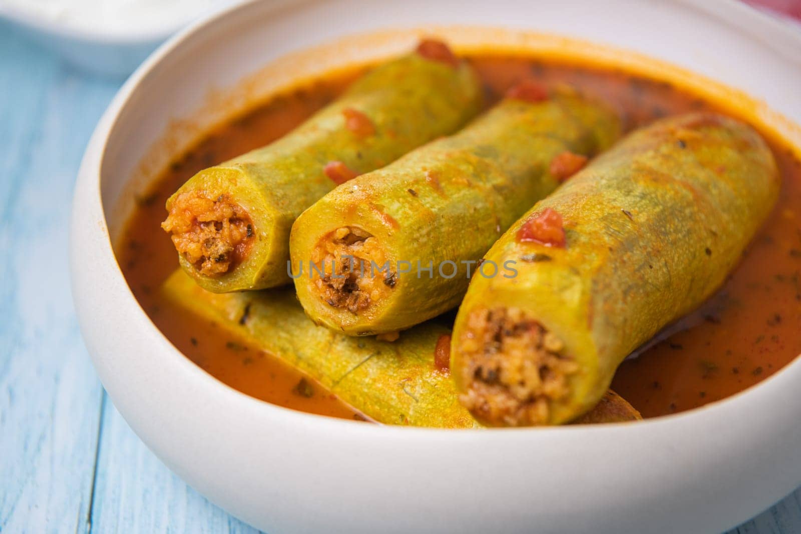 Recipe of stuffed courgette with tomato sauce, Lebanese style, Kouca Mehchi bi Banadoura, with Greek yogurt. High quality photo