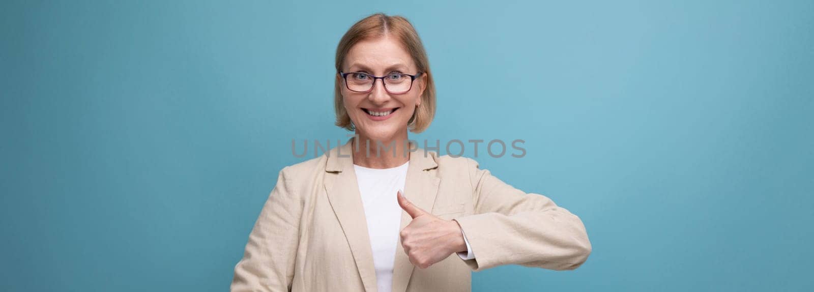 portrait of a business mature adult woman in a classic jacket on a bright background with copy space.