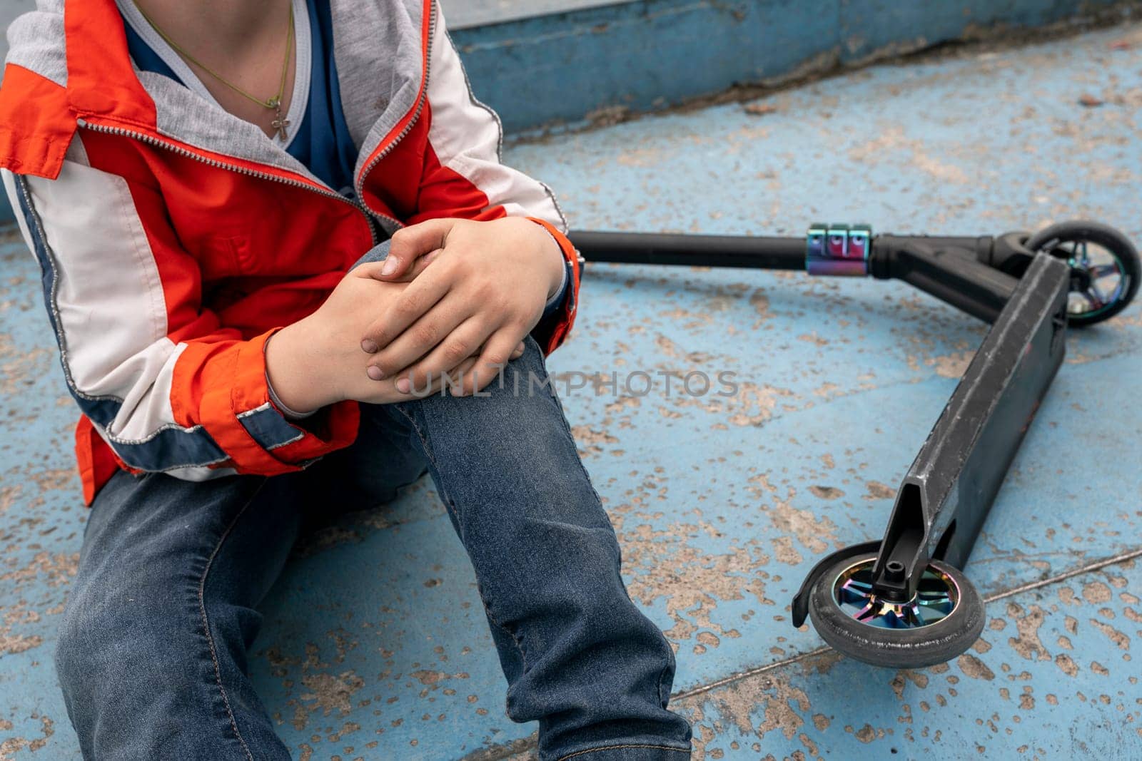 boy holds onto a bruised knee after falling from a stunt scooter by audiznam2609