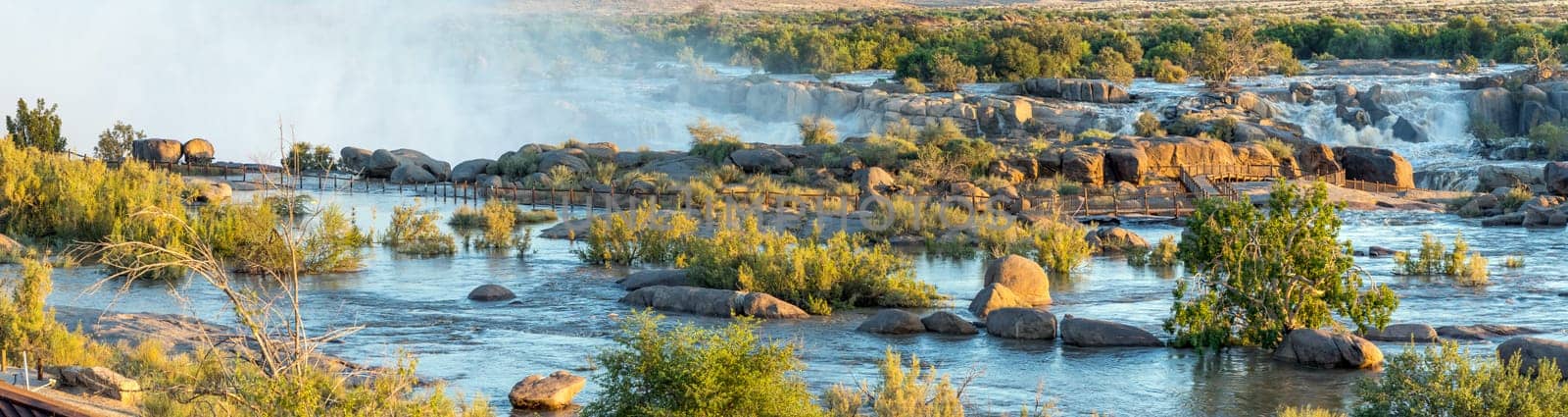 Augrabies National Park, South Africa - Feb 27, 2023: A stitched panorama of the partially flooded boardwalk to the main Augrabies waterfall. The Orange River is in flood