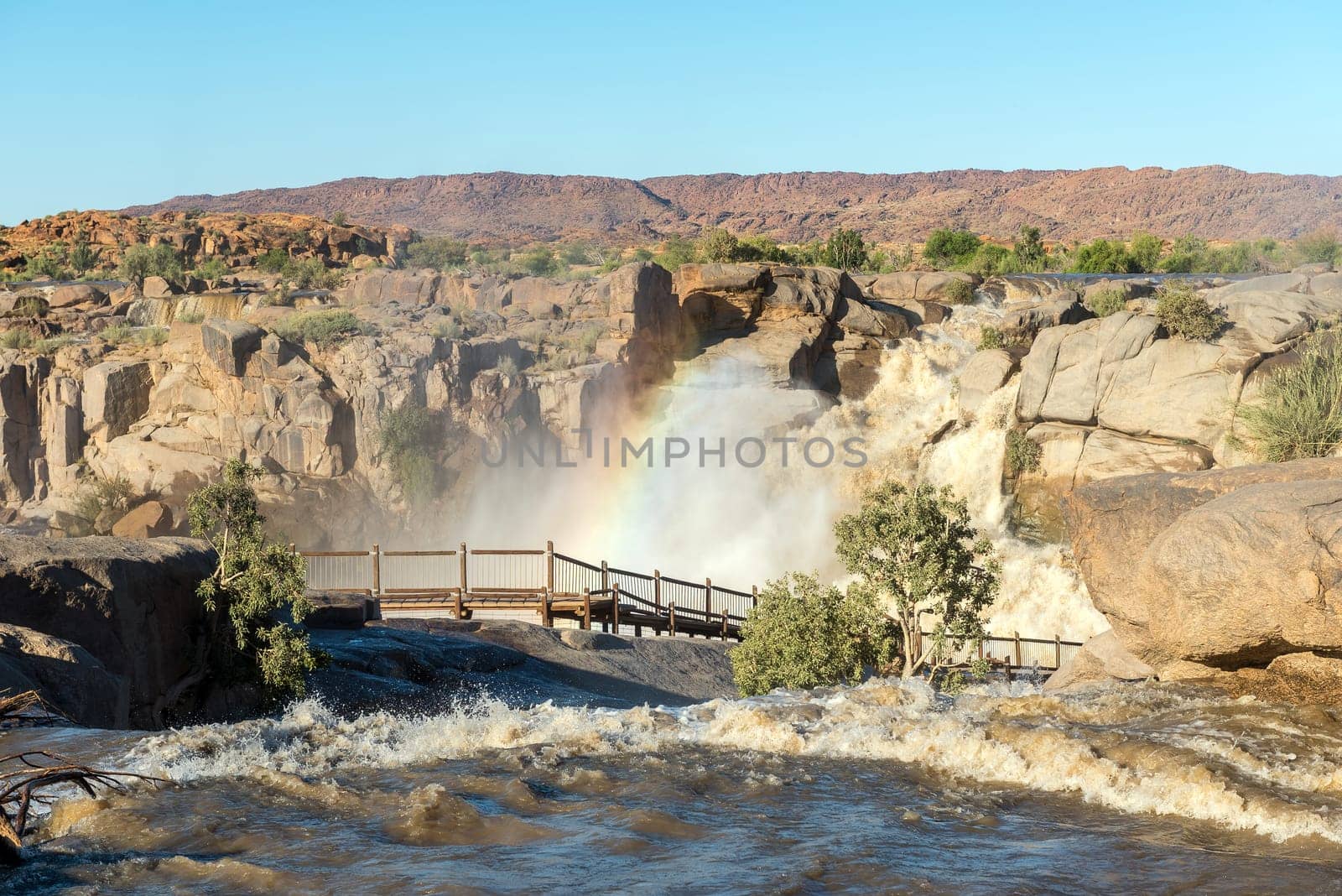 Rainbow over boardwalk at Augrabies Falls by dpreezg