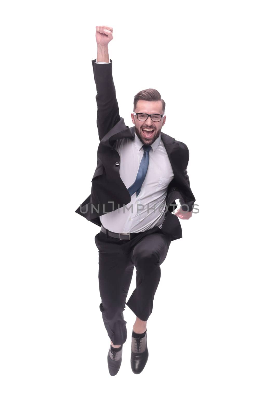 in full growth. happy dancing young businessman. isolated on white background