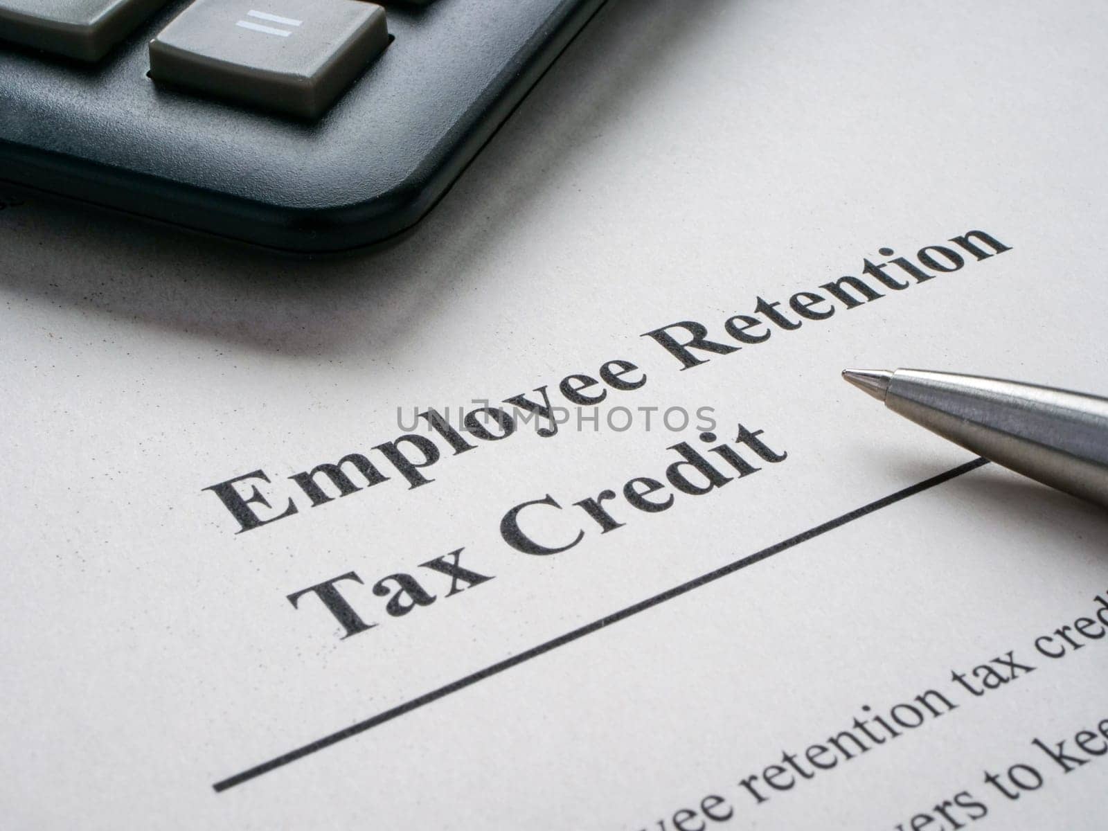 Page with info about employee retention tax credit and pen. by designer491