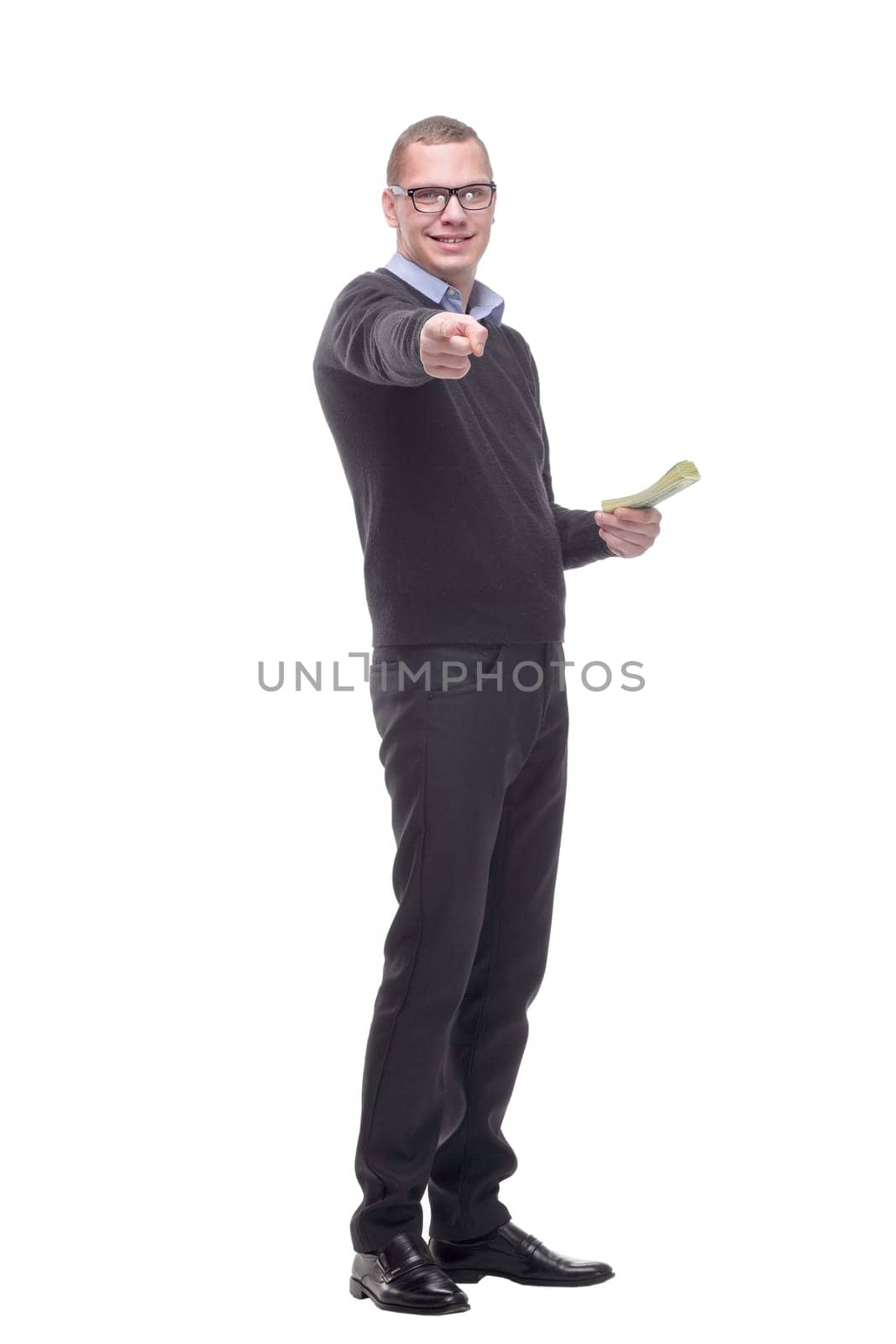 Portrait of a business man with hand in his pocket and holding money, isolated on white