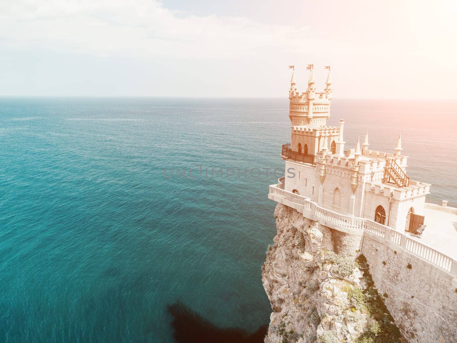 Aerial view of Swallow's Nest castle on the rock in Black Sea. It is a symbol and landmark of Crimea. Beautiful scenic panorama of the Crimea coast. Amazing Swallow's Nest at the precipice.