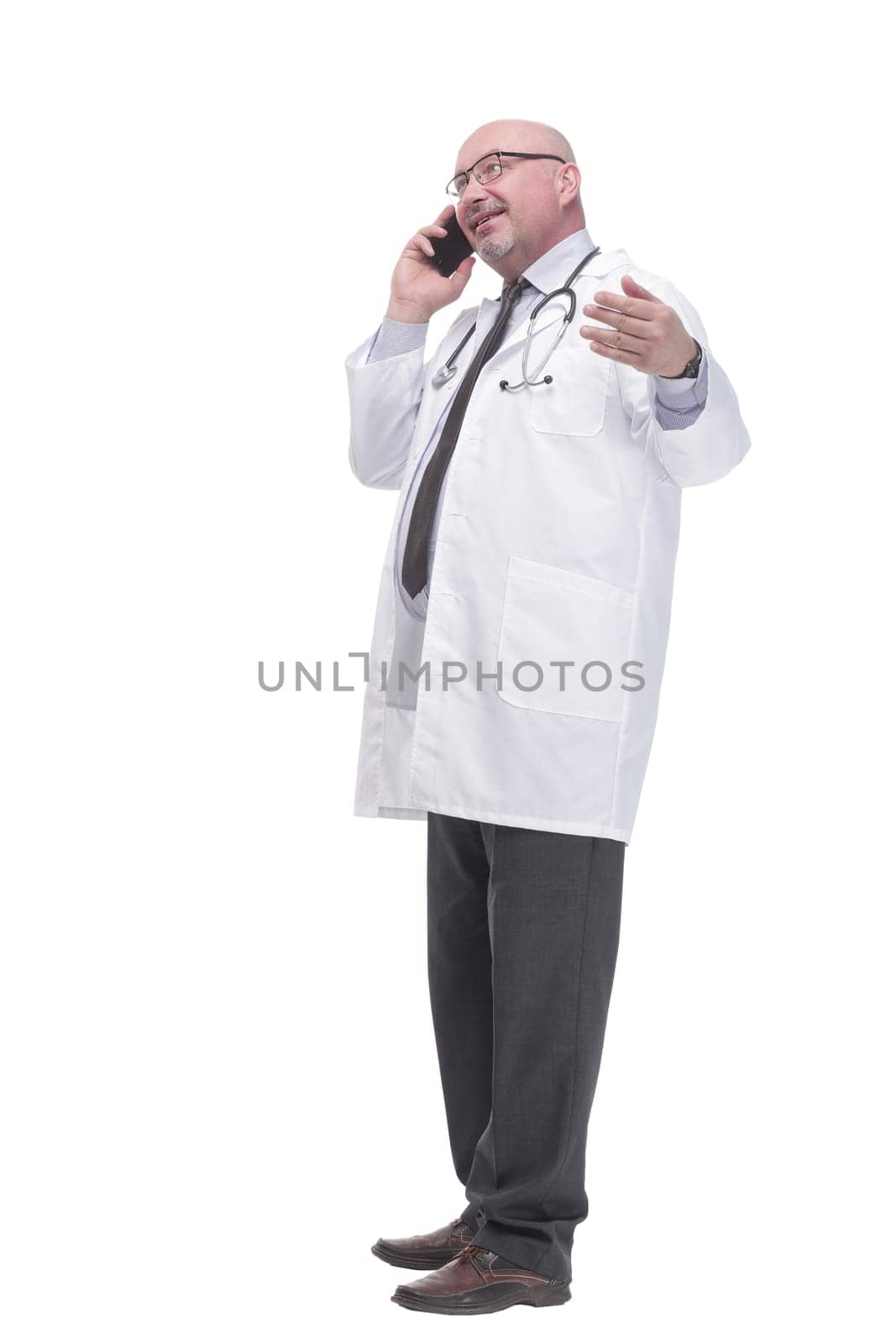 full-length. mature doctor with smartphone. isolated on a white background.