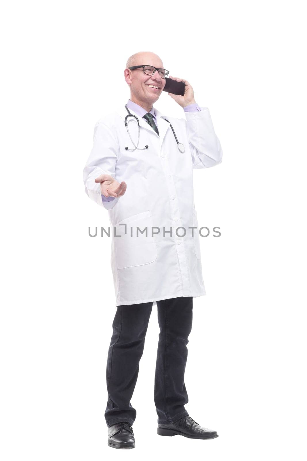 in full growth. smiling doctor with a smartphone. isolated on a white background.