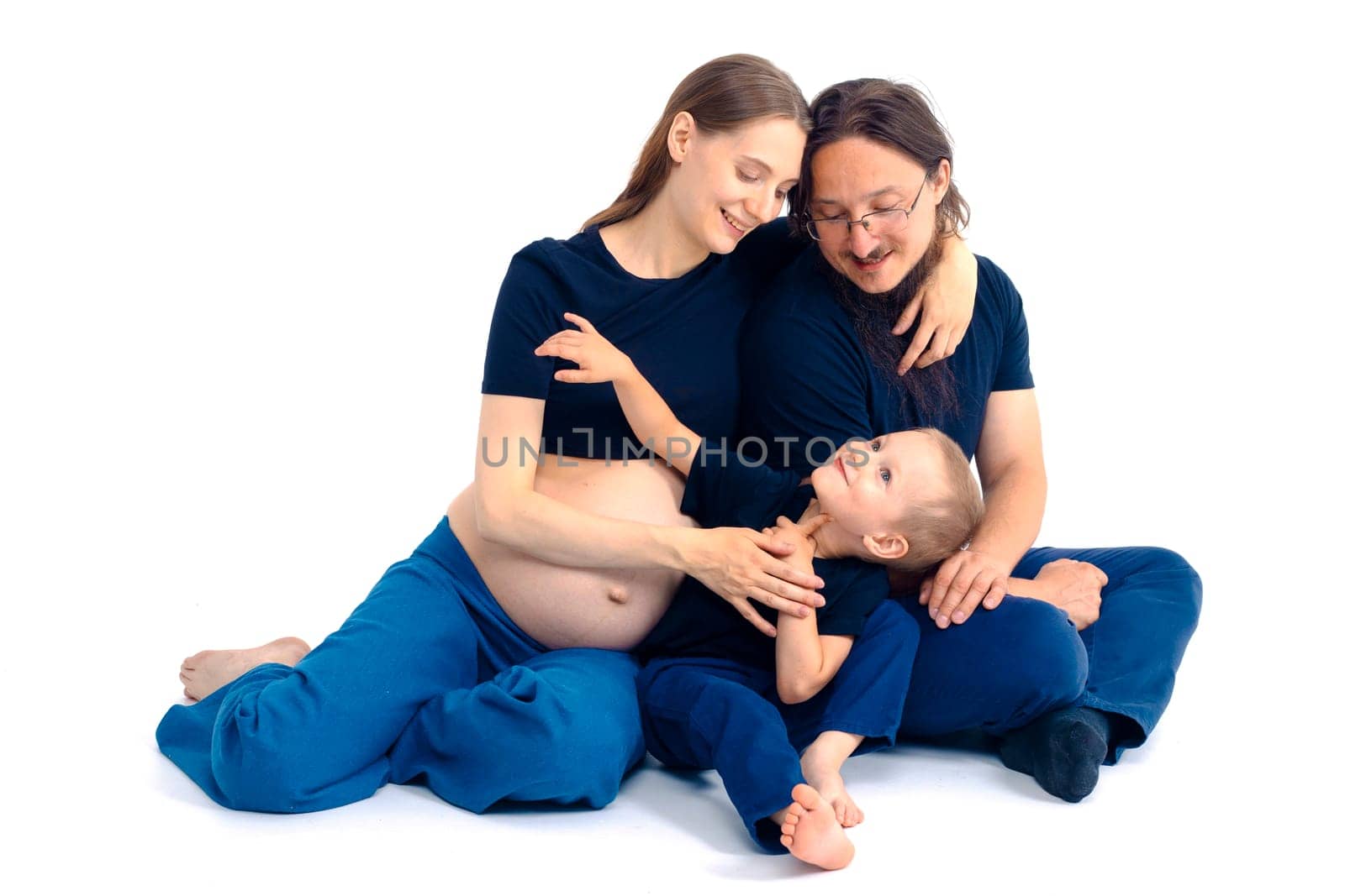 beautiful european happy family with a pregnant mother, the father and a son together. High quality photo