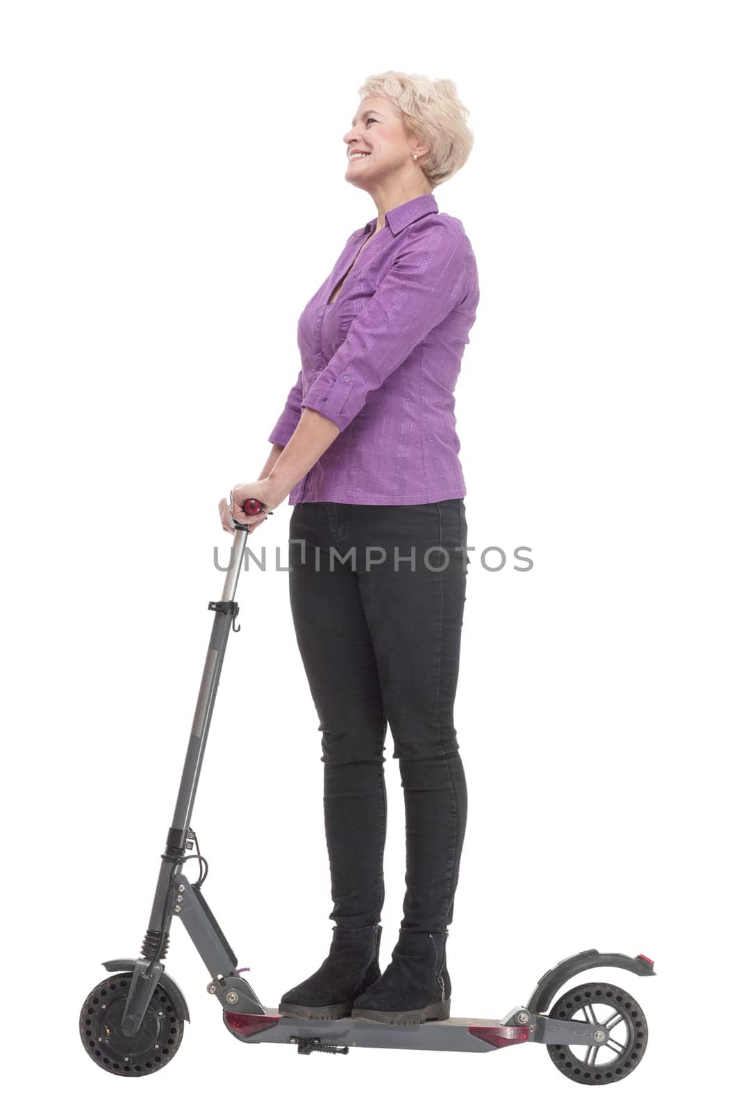 in full growth. smiling mature woman with an electric scooter . isolated on a white background.
